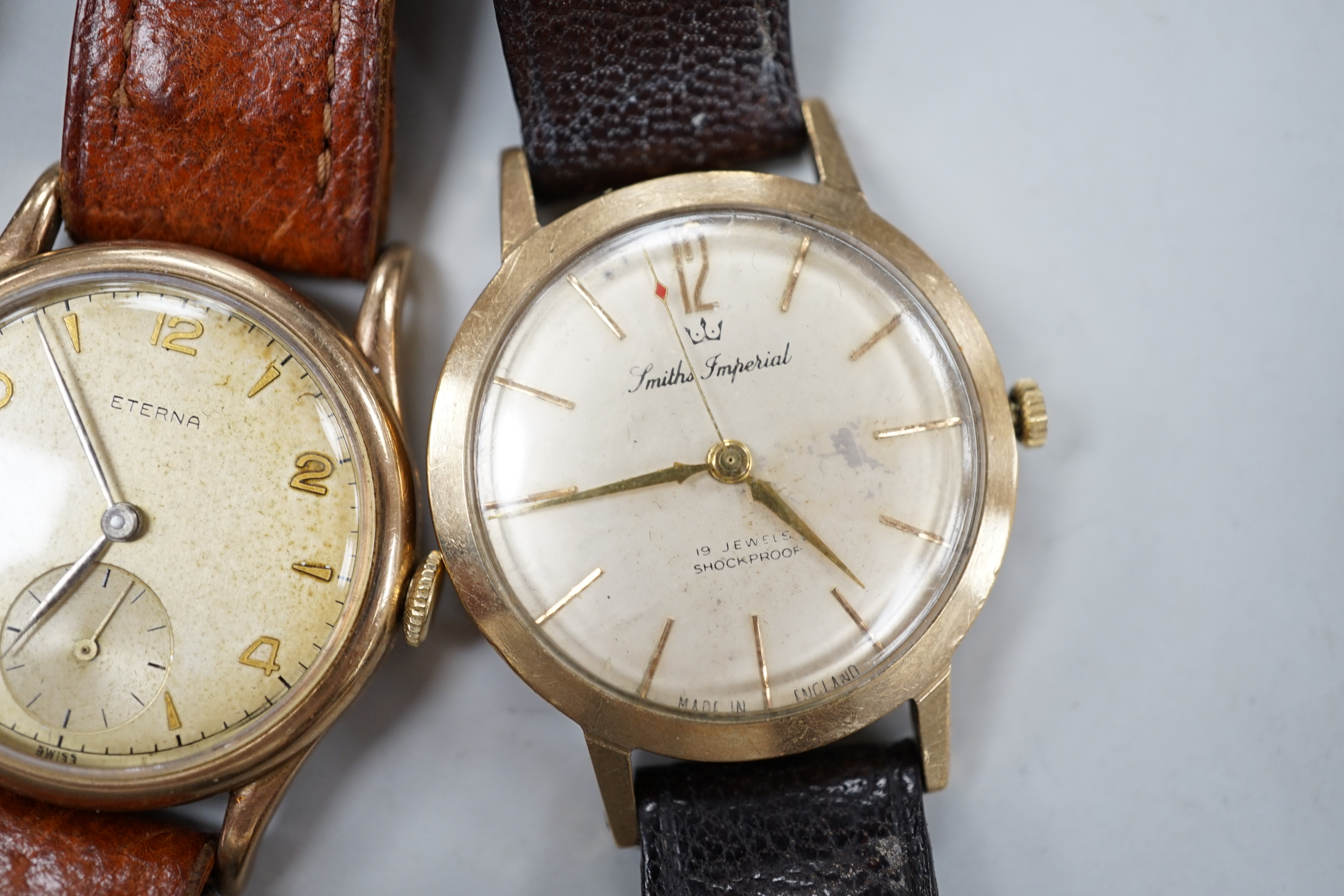 Two gentleman's 9ct gold manual wind wrist watches, retailed by Garrards, both with engraved inscription and two other 9ct gold wrist watches including Eterna.